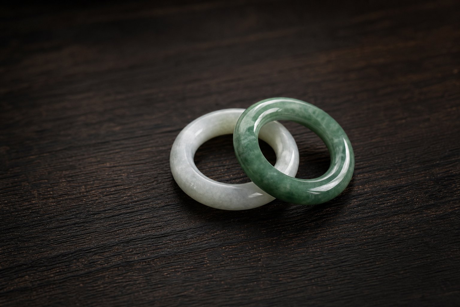 two jade rings in contrasting shades symbolizing how compound chinese names pair characters for layered meaning